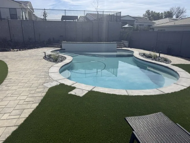 Freeform pool artificial turf backyard by Pinnacle Pools and Landscape, Sacramento CA