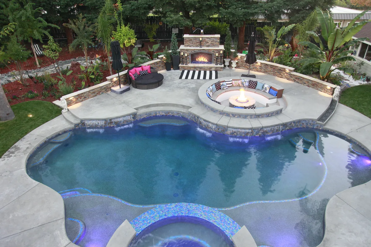 Freeform pool fire pit fireplace backyard by Pinnacle Pools and Landscape, Sacramento CA