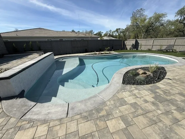 Freeform pool paver deck planter by Pinnacle Pools and Landscape, Sacramento CA