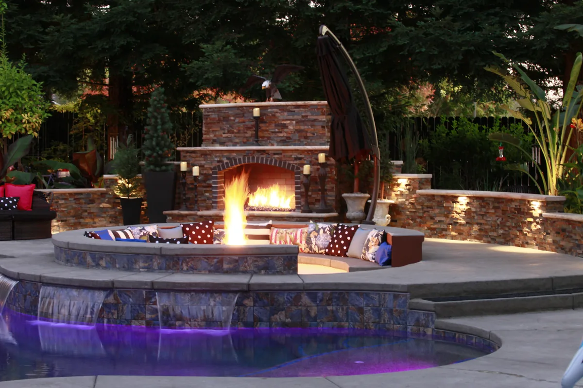 Outdoor fireplace pool color lighting night by Pinnacle Pools and Landscape, Sacramento CA