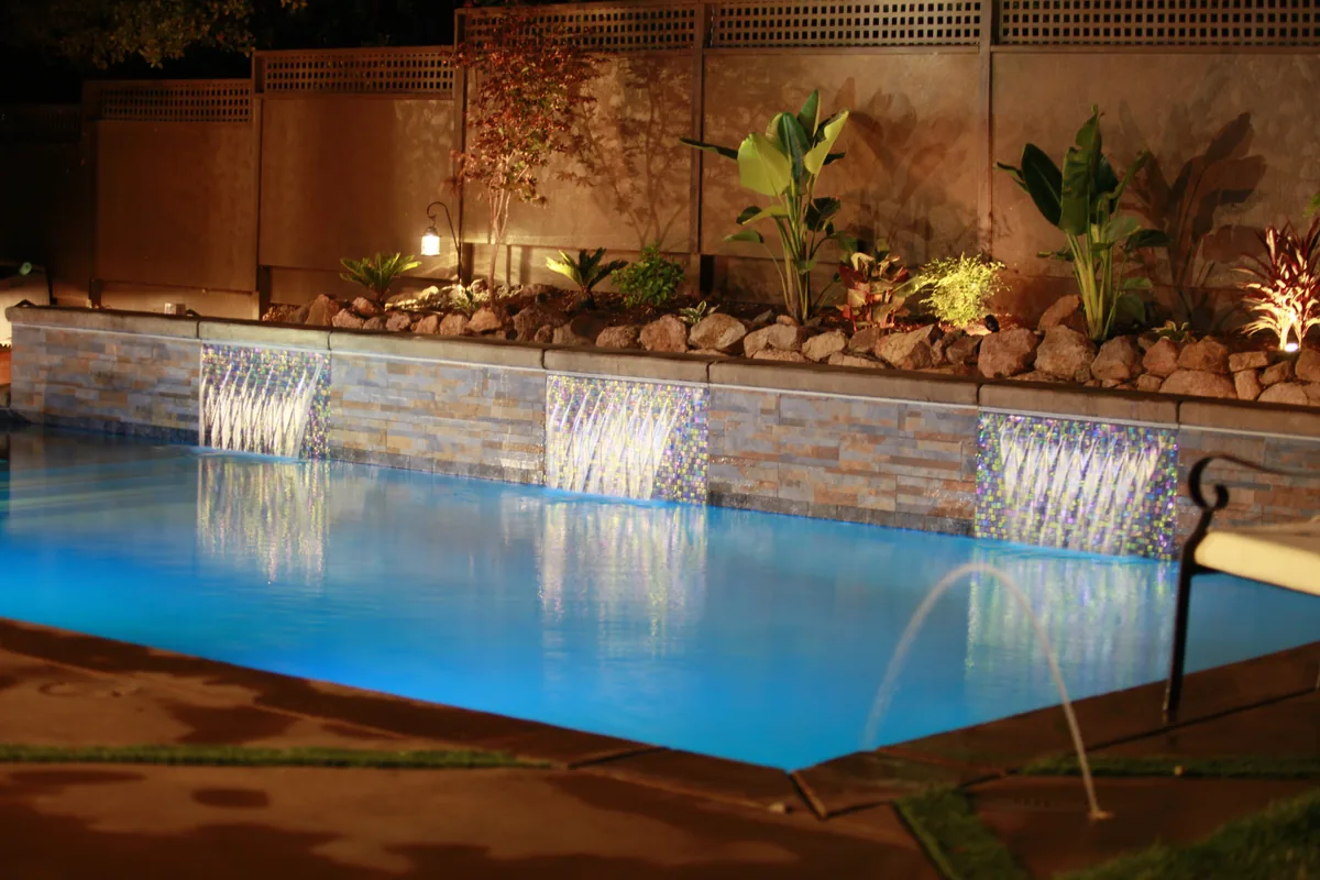 Pool deck jets water features night by Pinnacle Pools and Landscape, Sacramento CA