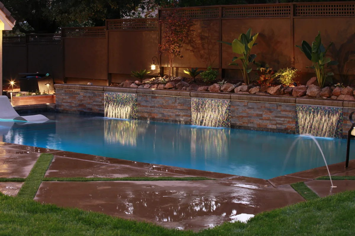 Pool water features landscape lighting night by Pinnacle Pools and Landscape, Sacramento CA