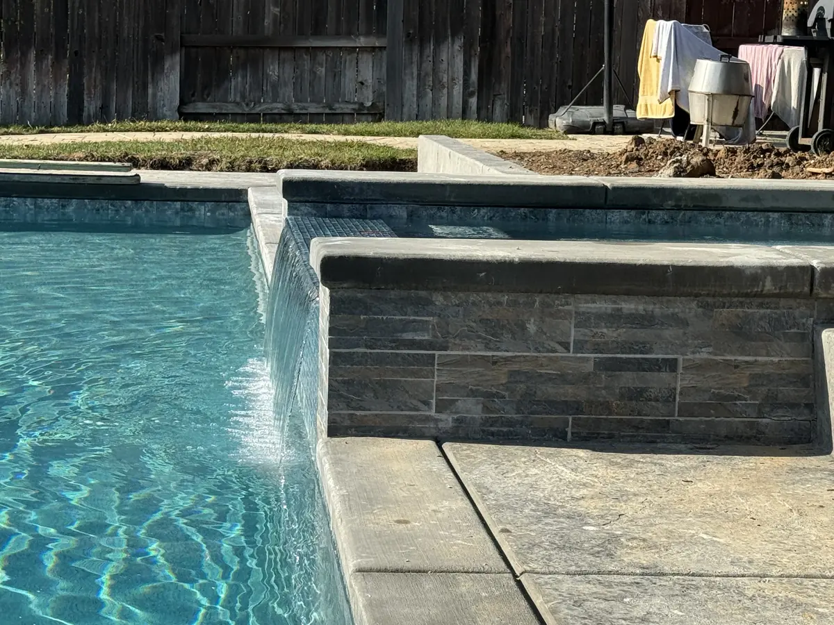 Pool waterfall stone veneer wall by Pinnacle Pools and Landscape, Sacramento CA