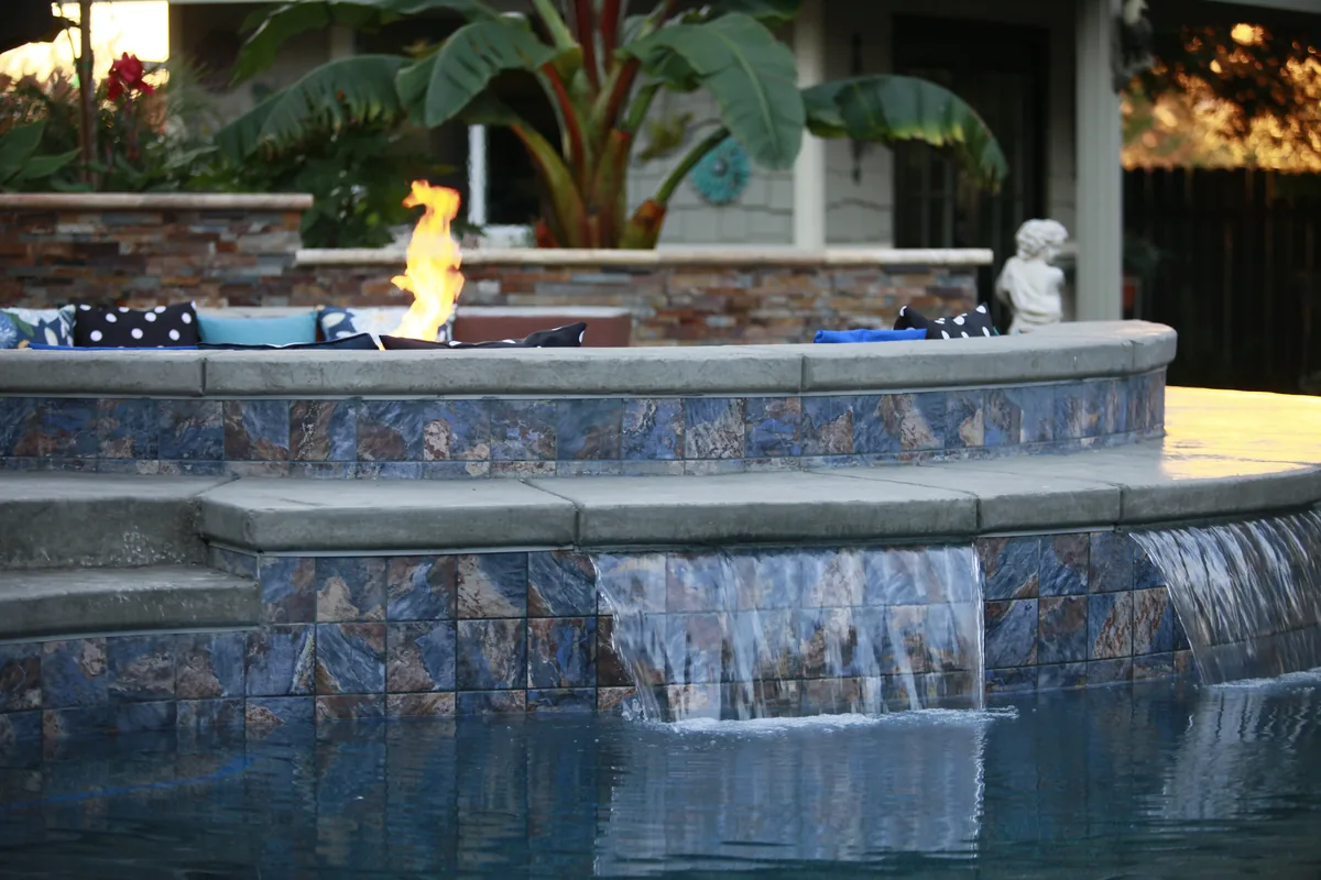 Raised spa fire bowl glass tile spillway by Pinnacle Pools and Landscape, Sacramento CA