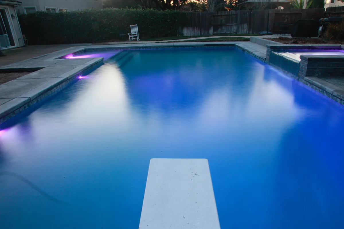 Rectangular pool diving board led night by Pinnacle Pools and Landscape, Sacramento CA