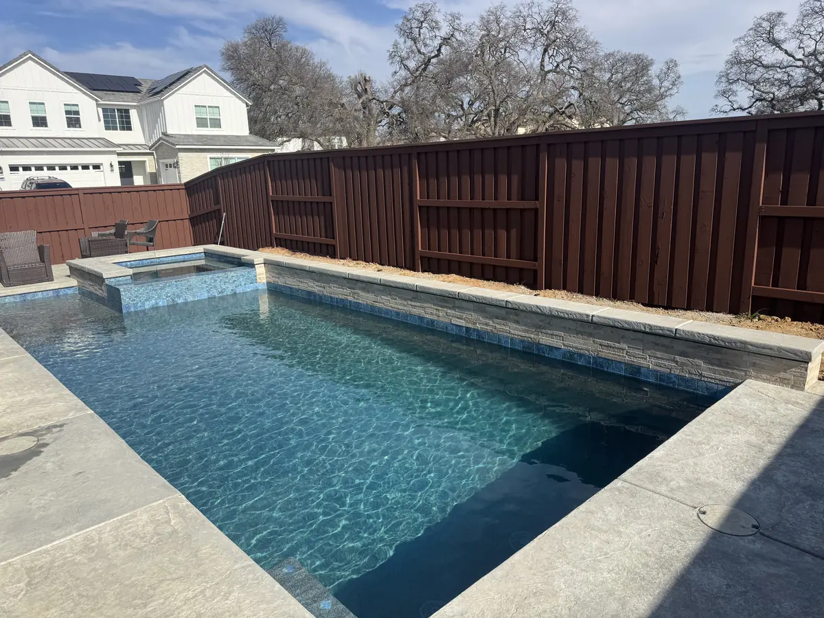 Rectangular pool raised spa spillway by Pinnacle Pools and Landscape, Sacramento CA