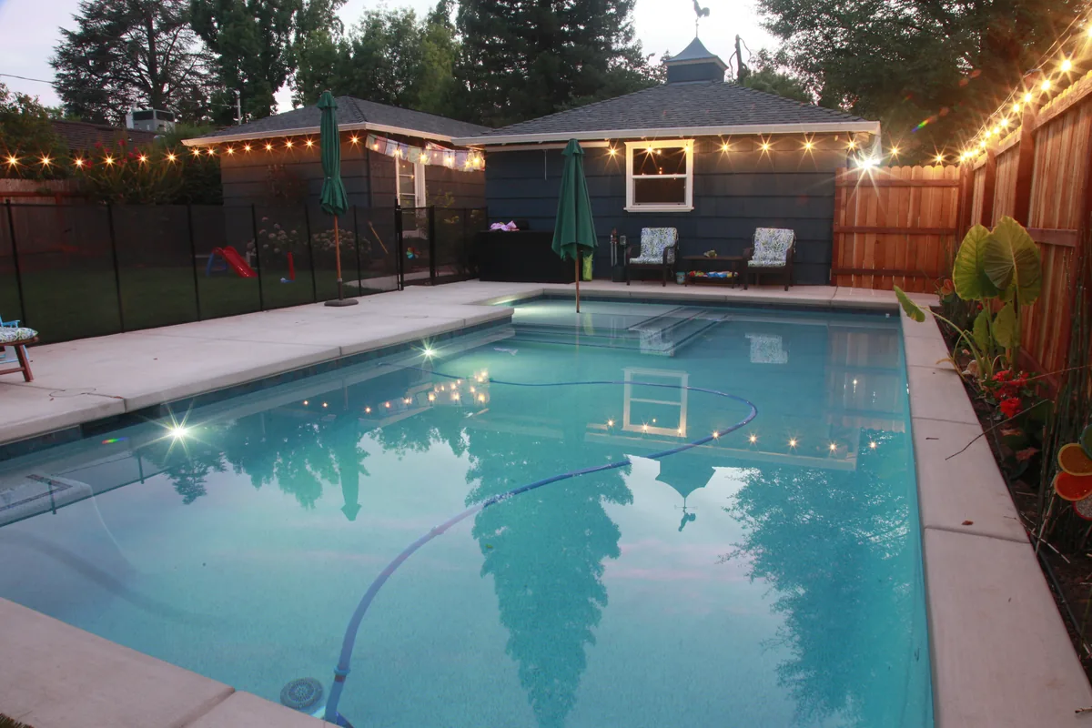 Rectangular pool string lights poolhouse by Pinnacle Pools and Landscape, Sacramento CA
