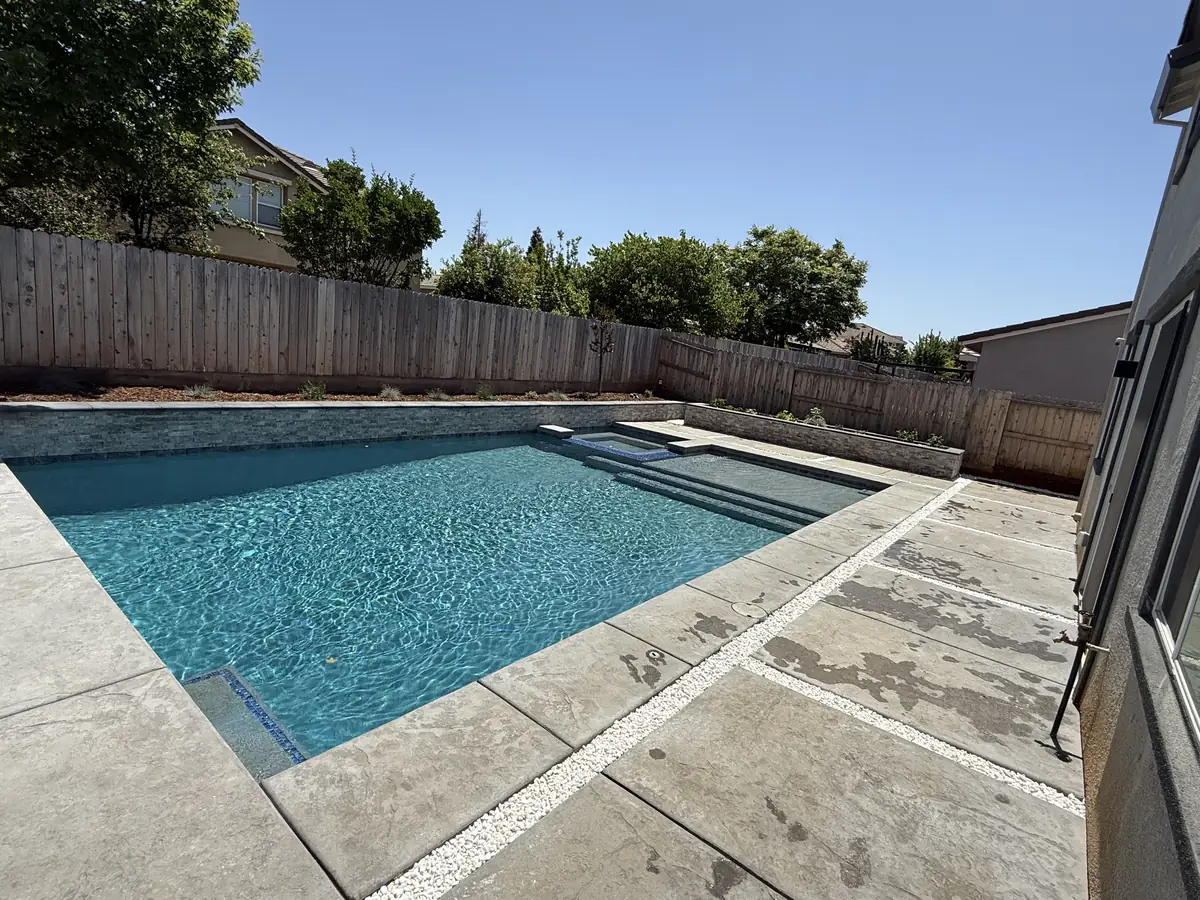Rectangular pool tanning ledge concrete deck by Pinnacle Pools and Landscape, Sacramento CA