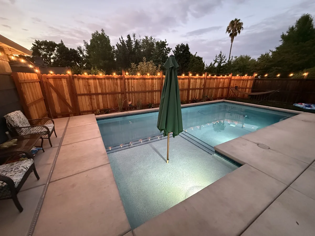 Small pool spa string lights patio by Pinnacle Pools and Landscape, Sacramento CA