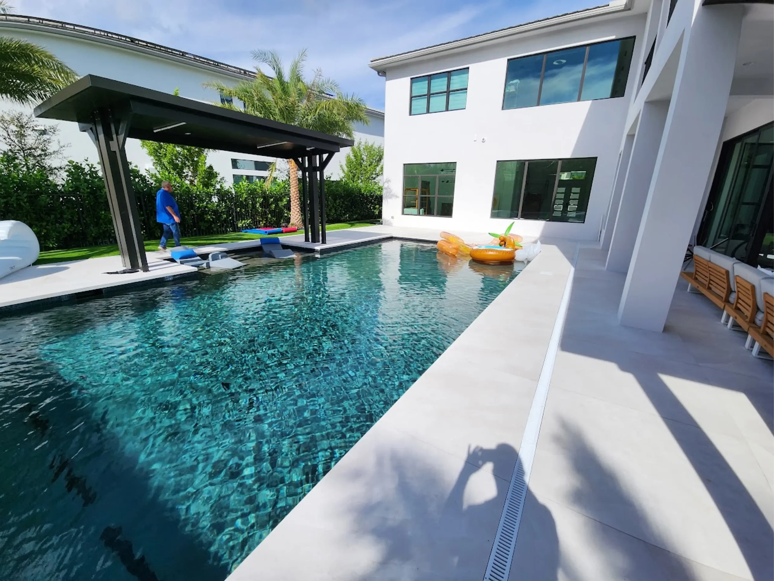 Modern rectangular pool with sun shelf and covered cabana